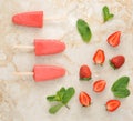 Strawberry yogurt ice cream popsicles with mint over marble tray Royalty Free Stock Photo