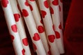 Close up photo of hearts on straws with red background. Royalty Free Stock Photo