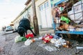 Stray dog eating garbage from containers