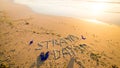 Straya text, flag and thongs on beach