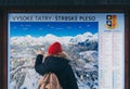 Strbske Pleso, Slovakia - December 2019: woman studying a map of High Tatra mountains