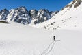 Winter tourism. A road through a snowy valley overlooking beautiful mountain peaks