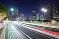 Streaking lights on Brickell key Drive with Brickell district skyline in Miami