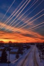 streaks of airplane contrails crisscrossing the sky at dusk