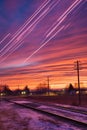 streaks of airplane contrails crisscrossing the sky at dusk