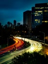 Streaks of light trails from cars zooming past the st kilda junction in melbourne during rush hour