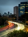 Streaks of light trails from cars zooming past the st kilda junction in melbourne during rush hour