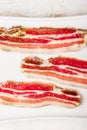 Streaky bacon with on the white plate vertical Royalty Free Stock Photo