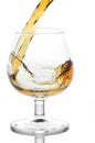 Stream of brandy falling in glass
