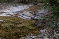 Stream of clean clear water flowing into shallow pool Royalty Free Stock Photo