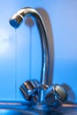 Tap with dripping waterdrop. Water leaking, saving. Royalty Free Stock Photo