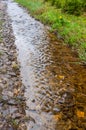 Water burble through an unpaved road after rain