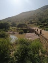 A stream flowing through a culvert with a beautiful vegetation and mountain in the background Royalty Free Stock Photo