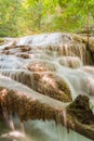 A stream flowing through foggy Autumn woodland at Erawan falls in Thailand National park Royalty Free Stock Photo