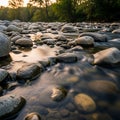 Stream flows over smooth rounded stones creating a gentle reflective Royalty Free Stock Photo