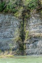 The stream flows from the rock into the riverbed