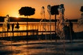Stream of a fountain splashes water, sunset Royalty Free Stock Photo