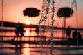 Stream of a fountain splashes water, sunset Royalty Free Stock Photo