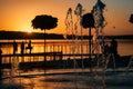 Stream of a fountain splashes water, sunset Royalty Free Stock Photo