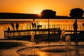 Stream of a fountain splashes water, sunset Royalty Free Stock Photo