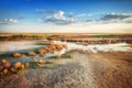 Stream of mineral water goes by dry ground under beautiful sky. Nature panorama near salt lake Elton. Astrakhan region, Russia