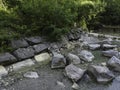 Stream in a natural area in Upper Bavaria with barrages and large stones at sunrise Royalty Free Stock Photo