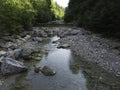 Stream in a natural area in Upper Bavaria with barrages and large stones at sunrise Royalty Free Stock Photo