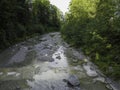 Stream in a natural area in Upper Bavaria with barrages and large stones at sunrise Royalty Free Stock Photo