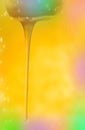 Stream of pouring honey. Honey flowing from a wooden honey spoon Royalty Free Stock Photo