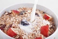 The stream of pouring milk in a bowl of cereal Royalty Free Stock Photo