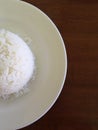 stream rice on dish and wooden table