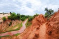 Stream running down a red canyon with green clover on the shore in Vietnam near Mui Ne