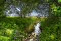 Stream in Saint Jean Port Joli with the Saint Lawrence river in the back Royalty Free Stock Photo