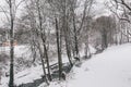 Stream surrounded by trees and roads covered in snow during storm Emma. Royalty Free Stock Photo