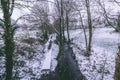 Stream surrounded by trees and roads covered in snow during storm Emma. Royalty Free Stock Photo