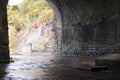 Stream Tunnel under Train Bridge Royalty Free Stock Photo