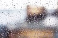 Stream of water in heavy rain. Raindrops on window pane Royalty Free Stock Photo