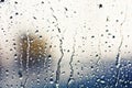 Stream of water in heavy rain. Raindrops on window pane. Royalty Free Stock Photo