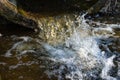 A stream of water pouring out of a concrete pipe Royalty Free Stock Photo