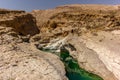 A stream of water in the rocky desert of Oman flowing in a canyon to the oasis of Wadi Bani Khalid - 2 Royalty Free Stock Photo