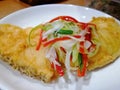 Streamed snow fish slice deep fries on top spring onion and chilies looking close up side.