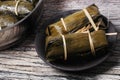 Streamed sticky rice and black bean in banana leaf .