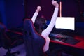 Streamer beautiful girl professional gamer winner rejoices in victory playing online games computer with headphones