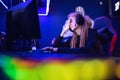 Streamer beautiful girl regrets losing professional gamer loser playing online games computer, neon color