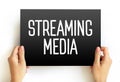 Streaming Media is multimedia that is delivered and consumed in a continuous manner from a source storage, text concept on card Royalty Free Stock Photo