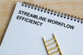 Streamline Workflow Efficiency text on white notepad. Efficient workflow concept Royalty Free Stock Photo