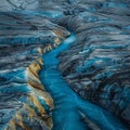 Streams of meltwater on Greenland glacier, vivid blue against a hot, barren landscape, side view, alarming
