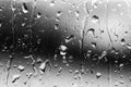 Streams of raindrops on window glass