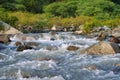 Streams and rocks between mountains with blue sky and green trees Royalty Free Stock Photo