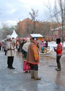 Street actors in colorful national costumes stand on the street.